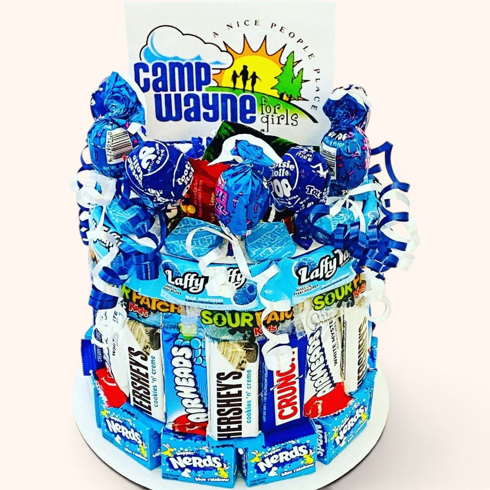 CandyCakeExplosion small camp candy cake featuring blue-themed gummies, sour chews, and treats with a camp sign.