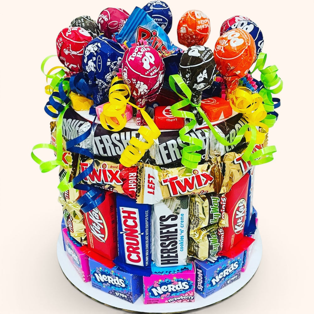 CandyCakeExplosion Small Lots Of Fun candy cake featuring assorted chocolate bars, lollipops, and Nerds boxes.