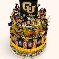 CandyCakeExplosion multi-tiered candy cake featuring CU Boulder branding, KitKats, Twix, and Haribo gummy bears.
