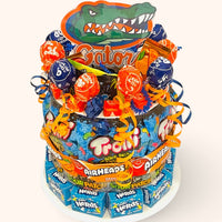 CandyCakeExplosion college themed candy cake featuring Gator mascot topper, assorted chocolates, and colorful candy bars.