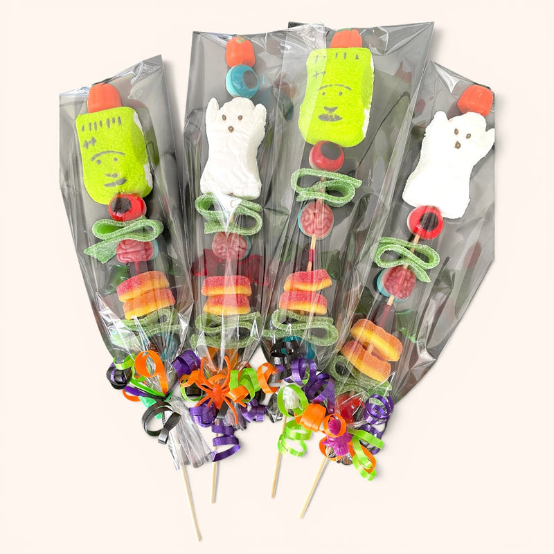 CandyCakeExplosion Halloween candy kabobs featuring spooky marshmallow ghosts and Frankenstein faces on skewers.