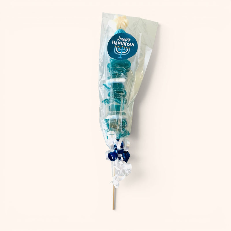 CandyCakeExplosion Hanukkah candy kabob with blue and white gummies, marshmallows, and a Happy Hanukkah sticker.
