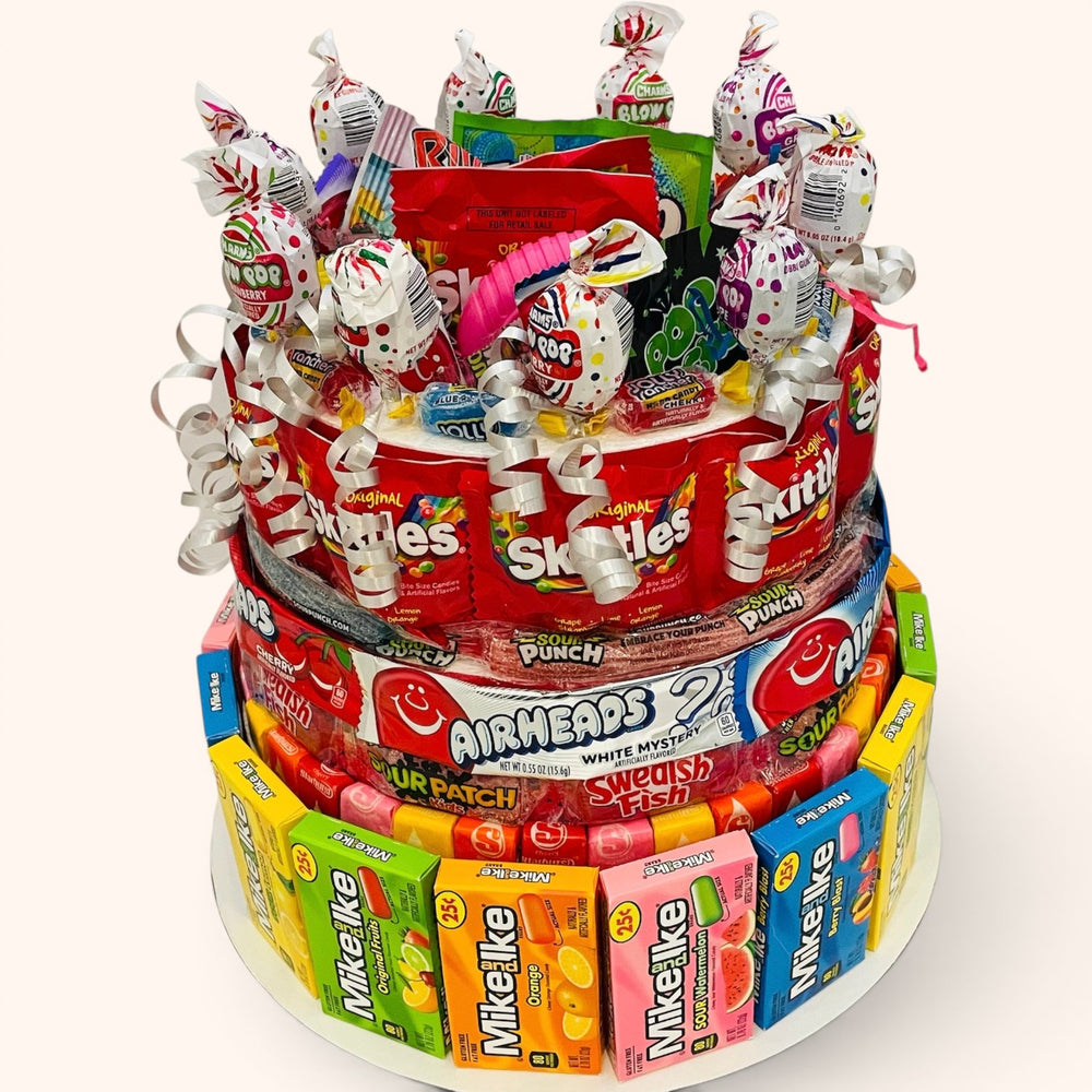 CandyCakeExplosion large multi-tiered candy cake featuring Skittles, Airheads, and Mike and Ike boxes.