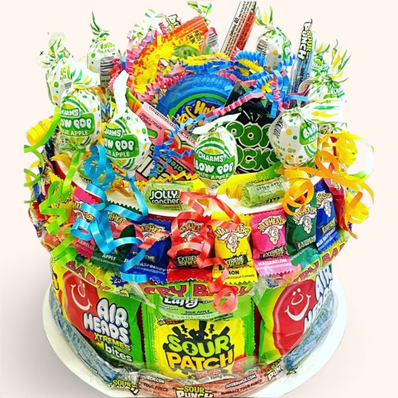 CandyCakeExplosion medium two-tier sour candy cake featuring Airheads, Sour Patch Kids, and green apple Blow Pops.