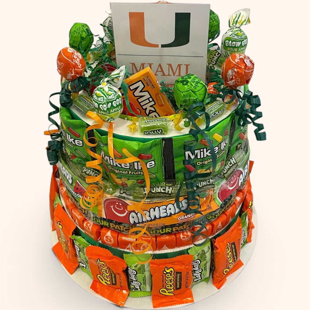 CandyCakeExplosion large multi-tiered candy cake featuring University of Miami branding, chocolates, and candy bars.