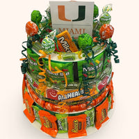 CandyCakeExplosion large multi-tiered candy cake featuring University of Miami branding, chocolates, and candy bars.