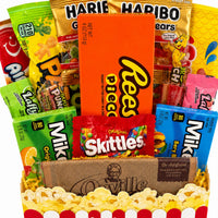 CandyCakeExplosion Movie Night Bouquet featuring assorted candy bars, Reese's Pieces, and popcorn in a gift basket