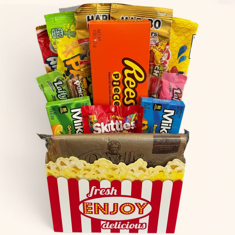 CandyCakeExplosion Movie Night Bouquet featuring assorted chocolates, candy bars, and popcorn in a theater-style box.