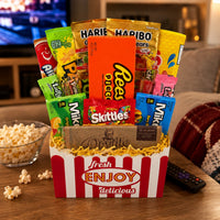 CandyCakeExplosion Movie Night Bouquet featuring assorted candy bars, chocolates, and popcorn in a cinema-style box.
