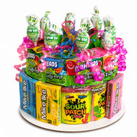 CandyCakeExplosion medium non-chocolate candy cake featuring sour gummy rings, Mike and Ike, and Charms Blow Pops.