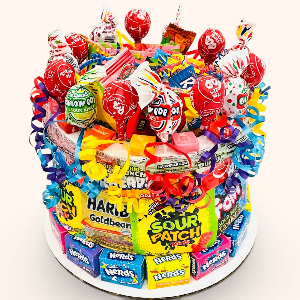 CandyCakeExplosion medium sweet and sour candy cake featuring assorted gummies, lollipops, and fruity chews.
