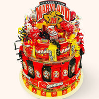 CandyCakeExplosion University of Maryland candy cake with assorted chocolates, candy bars, and festive red and yellow decor